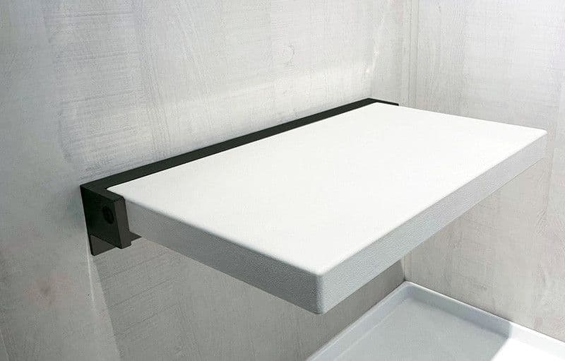 A white folding shower bench seat.