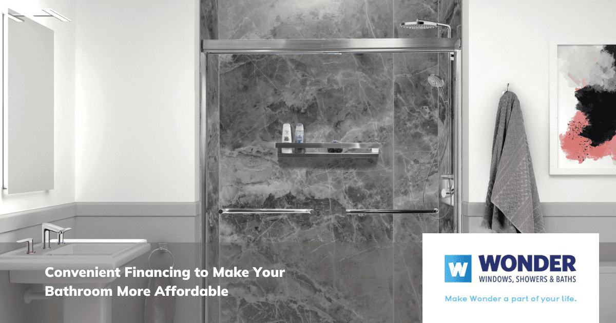 Modern bathroom with gray marble shower, glass door, and sleek fixtures. Towels hang nearby. Text reads, "Convenient Financing for Your Bathroom."