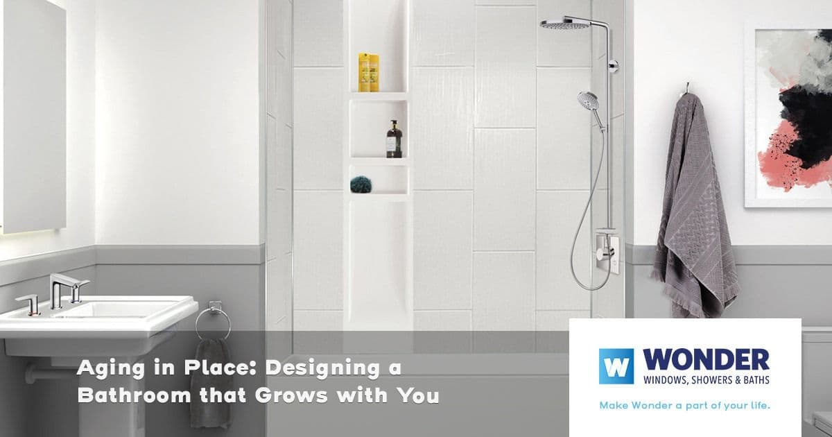 Modern bathroom with a white shower, built-in shelves, and sleek fixtures. Towels and art add warmth. Text: "Aging in Place: Designing a Bathroom that Grows with You." Logo: "WONDER Windows, Showers & Baths."
