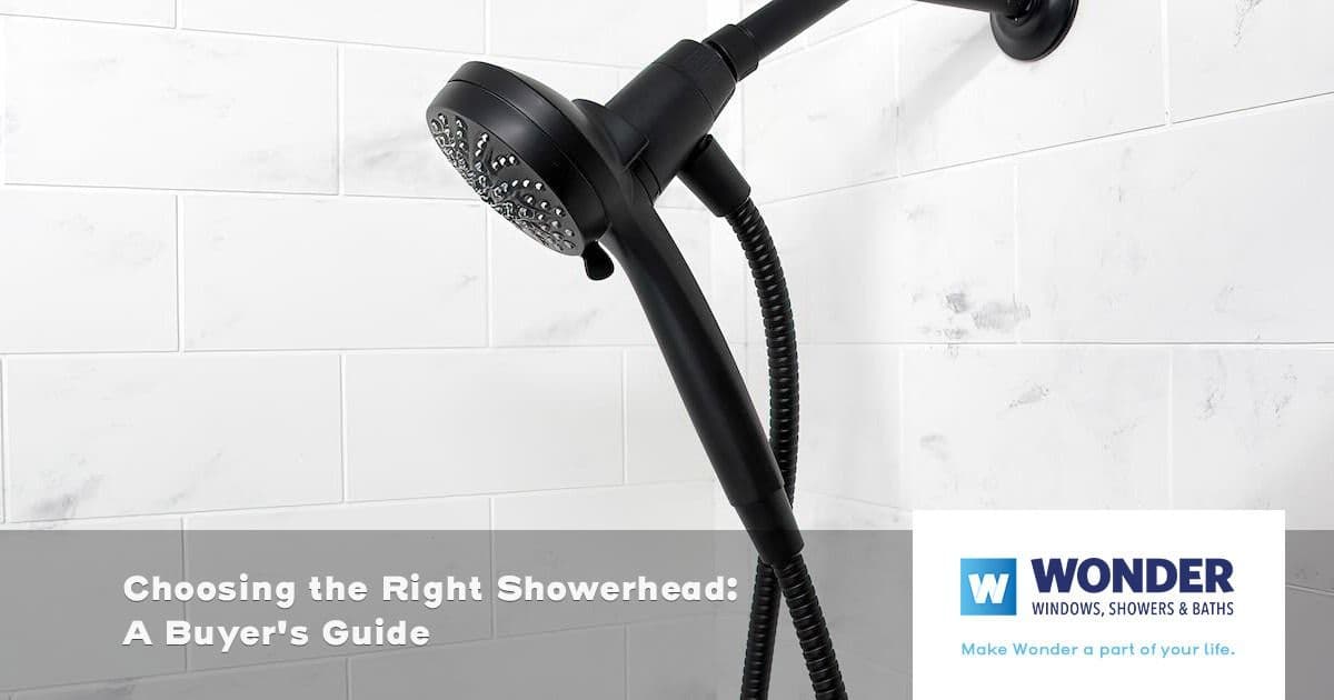 A modern black showerhead with a flexible hose is mounted on a white tiled wall. Text overlay reads, "Choosing the Right Showerhead: A Buyer's Guide." Logo in the corner says "Wonder Windows, Showers & Baths."