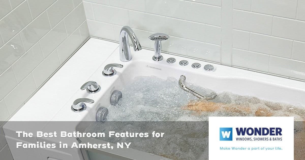 A modern bathtub with bubbling water and sleek silver fixtures. Text overlay: "The Best Bathroom Features for Families in Amherst, NY." Wonder logo.