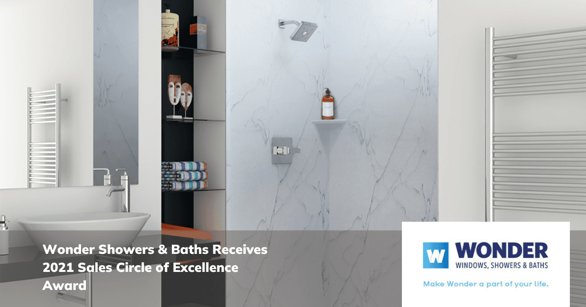 Elegant bathroom with marble shower, modern vanity, and towel racks. Text overlay announces award for Wonder Showers & Baths. Clean, sleek design.