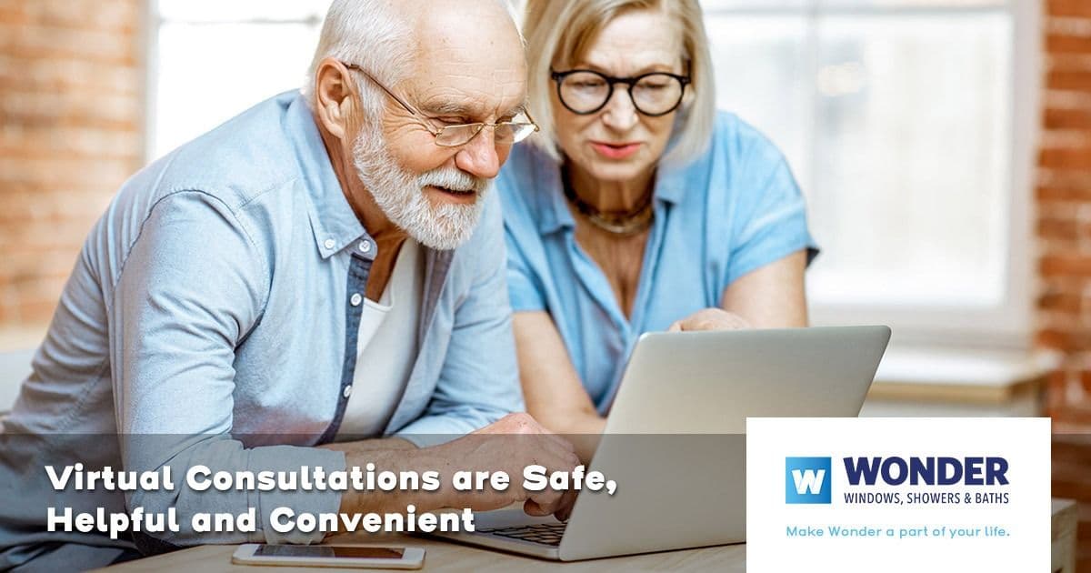 two elderly people looking at a computer