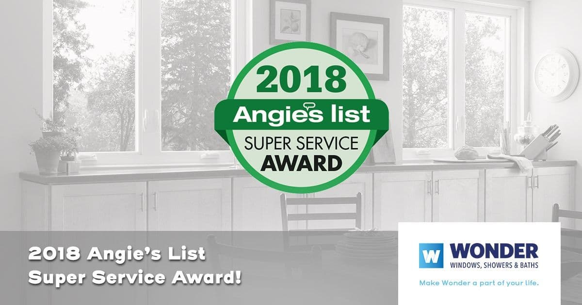 Alt text: "A 2018 Angie's List Super Service Award badge is centered over a bright kitchen background. The logo for Wonder Windows, Showers & Baths is at the bottom right. Text reads, '2018 Angie's List Super Service Award!' creating a tone of achievement and professionalism."