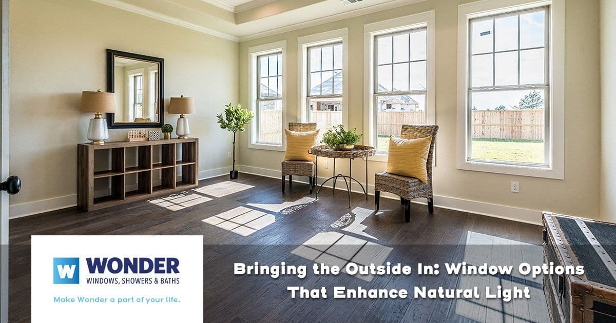 Bright room with six large windows letting in natural light, wicker chairs with yellow cushions, and a wooden console with decor. Text overlay: "Bringing the Outside In: Window Options That Enhance Natural Light." Logo: Wonder Windows, Showers & Baths.