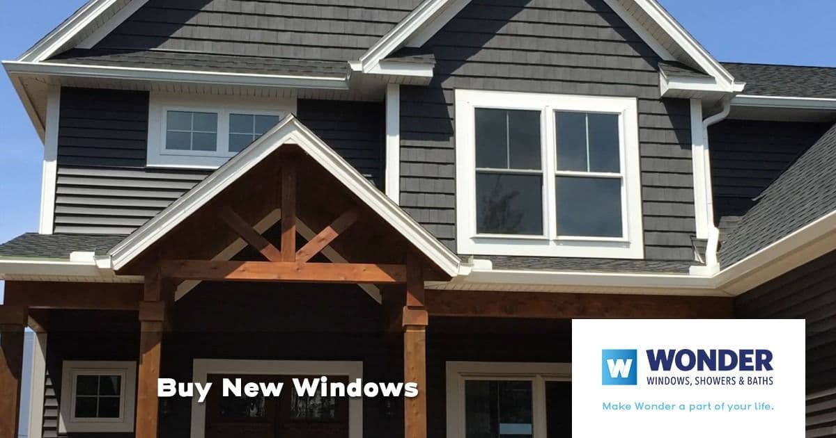 A modern house with dark gray siding and large white-framed windows. Text reads "Buy New Windows." Wonder Windows logo is featured in the bottom right.