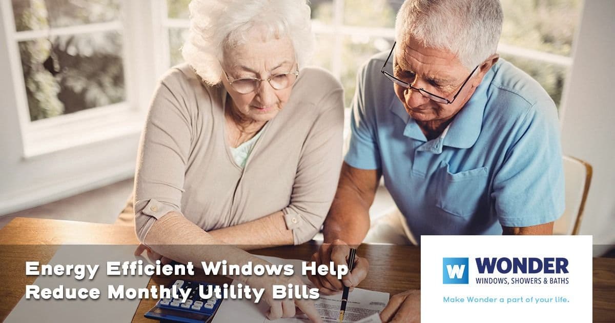 Elderly couple reviewing bills at a table, calculator and papers present. Text reads "Energy Efficient Windows Help Reduce Monthly Utility Bills."