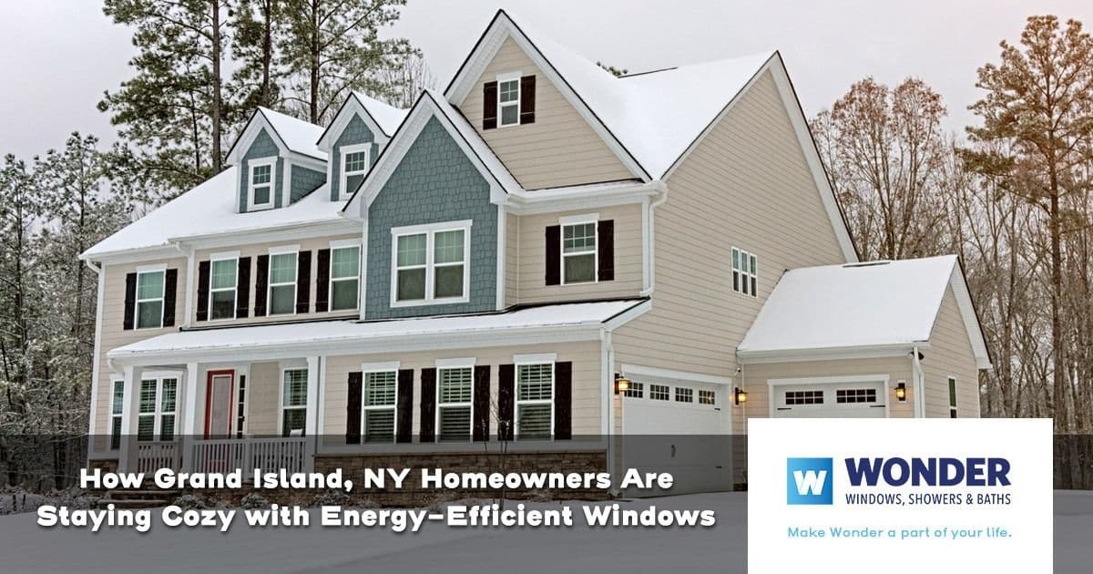 A large house covered in snow features energy-efficient windows. Text overlay highlights cozy homes in Grand Island, NY. Logo of Wonder Windows.
