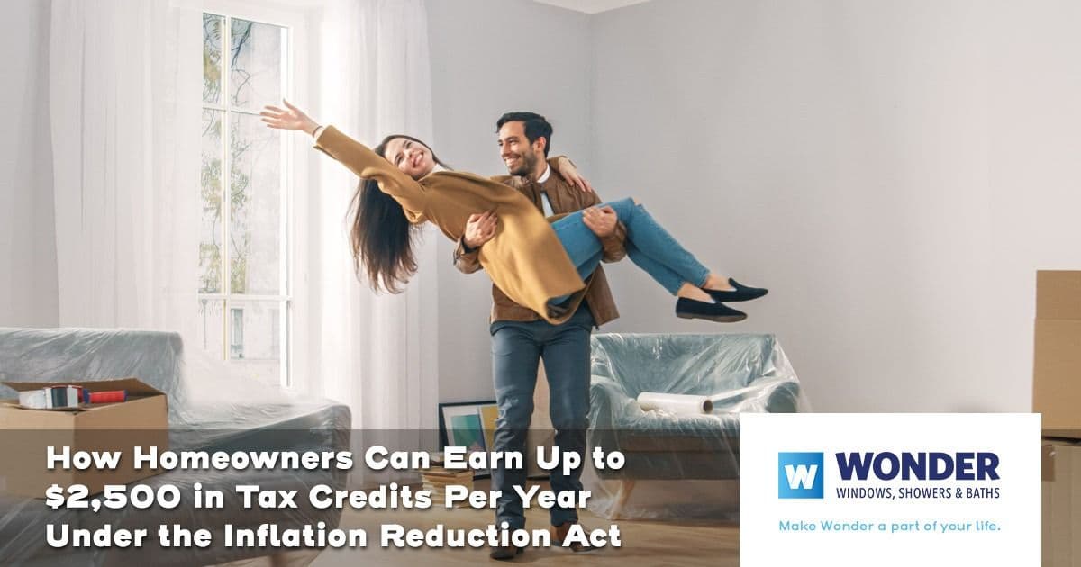 A joyful couple dances in a living room surrounded by moving boxes and furniture. Text overlay discusses tax credits for homeowners.
