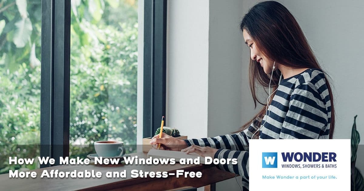 Smiling woman writing at a table near large, bright windows. Text overlay reads: "How We Make New Windows and Doors More Affordable and Stress-Free." Wonder Windows logo present.