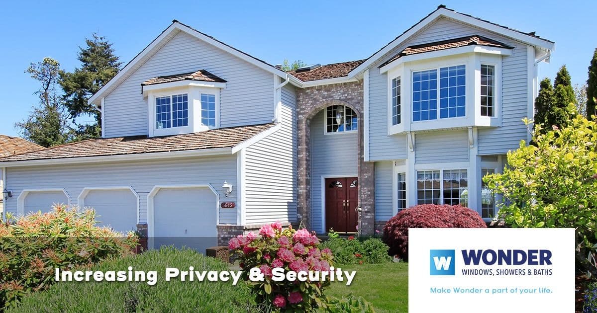 A suburban house with large windows, lush garden, and the text “Increasing Privacy & Security.” Logo: Wonder Windows, Showers & Baths in the corner.