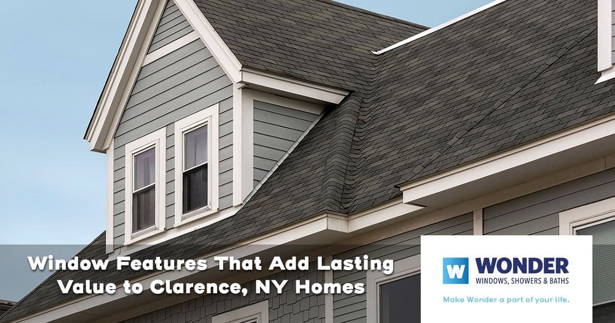 Exterior view of a gray house with a pitched roof and white-trimmed windows. Text overlay reads: "Window Features That Add Lasting Value to Clarence, NY Homes." Wonder Windows logo at the bottom right.