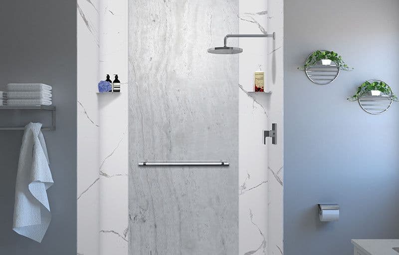Modern bathroom with a minimalist design. Features a walk-in shower with white marble walls, a silver rain showerhead, and a towel rack.