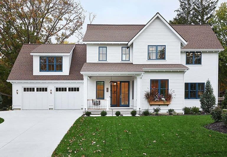 New replacement windows on a white house by Wonder Windows, Showers & Baths.